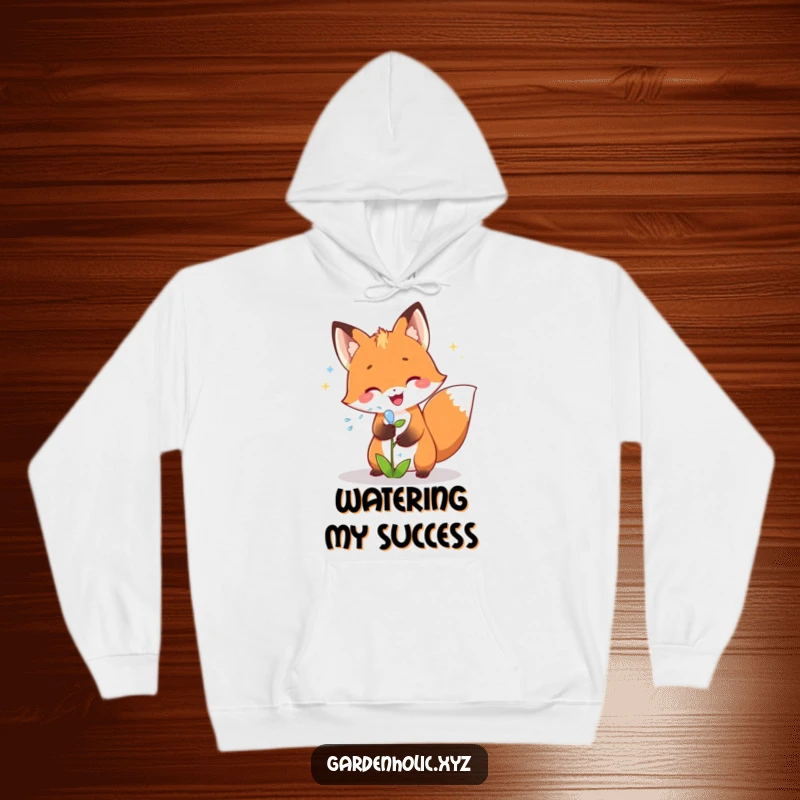 Funny fox hoodie featuring a joyful fox showering a small plant with sparkling water, perfect for a comfy, fun gift.