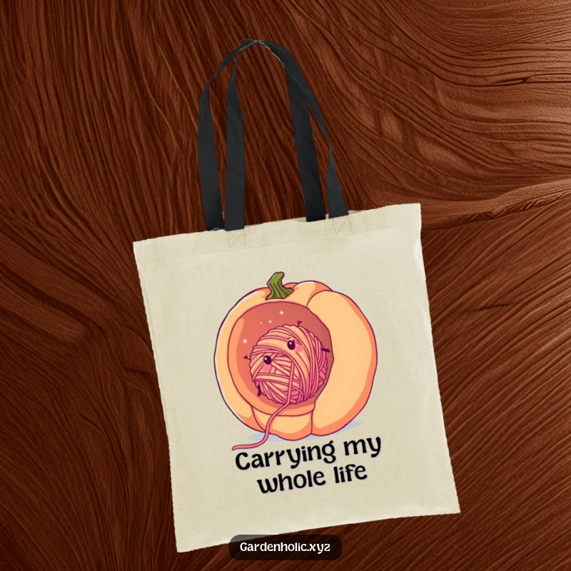 Funny yarn pumpkin tote bag with a cheerful, fuzzy ball of yarn rolling downhill inside a giant pumpkin, showcasing fall crafting humor.